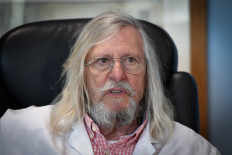 French professor Didier Raoult, biologist and professor of microbiology, specialized in infectious diseases and director of IHU Mediterranee Infection Institute posing in his office in Marseille, southeastern France, on February 26, 2020. 