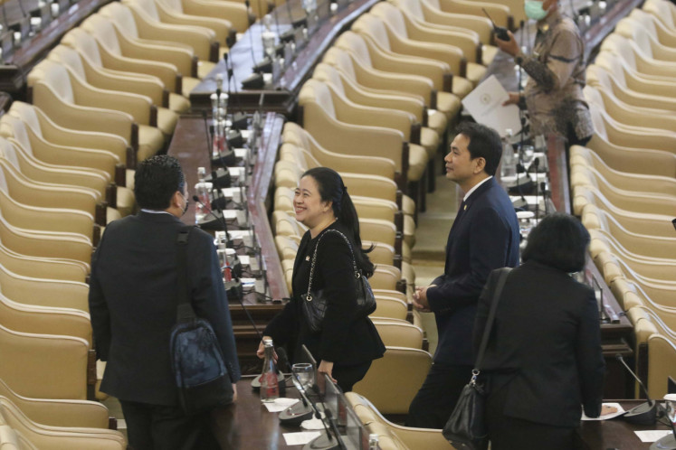 Chairman of the House of Representatives (DPR), Puan Maharani (center) smile after attending the Plenary Meeting session at the Parliament Complex Senayan, Jakarta, on, Monday, March 30, 2020.