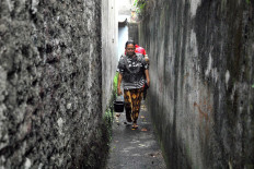 Handayani walks in a narrow alley in Pesanggrahan, South Jakarta. JP/Rahmat Dian Prasanto