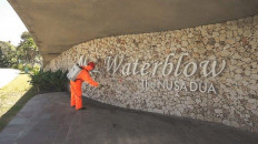 A worker sprays disinfectant at The Nusa Dua in Bali.