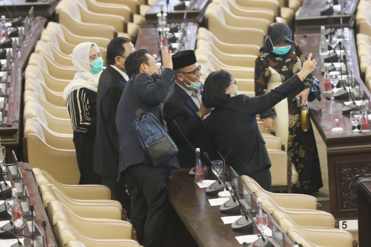Member of the House of Representatives (DPR) take a photo after attending the Plenary Meeting Session at the Senayan Parliament Complex, Jakarta, on Monday, March 30, 2020. 