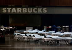 Beds are set up in front of a large Starbucks sign at the CenturyLink Field Event Center, which is being turned into a military field hospital for non coronavirus patients during the coronavirus disease (COVID-19) outbreak in Seattle, Washington, U.S. March 30, 2020.  