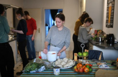 Student Lana (center) and her flatmates prepare self-made pizzas in the kitchen of a flat-sharing in Dortmund, western Germany, on March 27, 2020, amidst the pandemic of the new coronavirus COVID-19. 