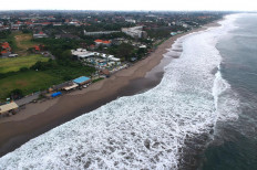 Tidal froth gathers in the shallows off Batu Belig Beach on April 1, 2020, a popular tourist destination west of Bali’s provincial capital Denpasar that was temporarily closed to prevent the spread of COVID-19.