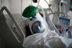 A patient suffering from COVID-19 wears a full-face Easybreath snorkeling mask given by sport chain Decathlon and turned into a ventilator for coronavirus treatment at the intensive care unit at Ambroise Pare clinic in Neuilly-sur-Seine near Paris, as the spread of the coronavirus disease continues in France, April 1.  