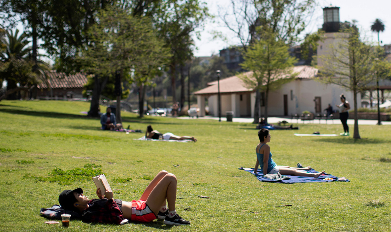 People practice social distancing as they enjoy the outdoors by Echo Park Lake during the global outbreak of the coronavirus disease (COVID-19), in Los Angeles, California, US, last Friday. 