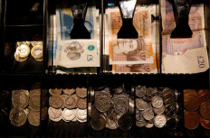 Pound Sterling notes and change are seen inside a cash register in a coffee shop in Manchester, Britain, on Sept. 21, 2018.