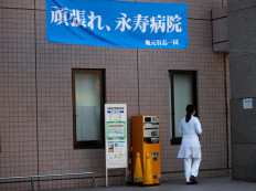 Japan virus cases surge over 10,000 with hospitals stretched