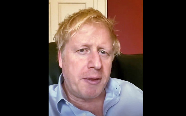 A still image from footage released by 10 Downing Street, the office of the British prime minister, on April 3, 2020 shows Britain's Prime Minister Boris Johnson in 10 Downing Street central London giving an update on his condition after he announced that he had tested positive for the new coronavirus on March 27, 2020. - British Prime Minister Boris Johnson was in 