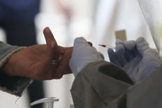 Sampoerna factory closes after two COVID-19 deaths, authorities race to trace contacts