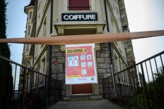 This picture shows a closed hairdresser shop amid the spread of the COVID-19 caused by the novel coronavirus, in Lausanne on March 21, 2020. 
