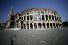 A general view shows a deserted area by the Coliseum monument in Rome on April 10, 2020 during the country's lockdown aimed at curbing the spread of the COVID-19 infection, caused by the novel coronavirus. 