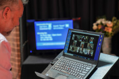 Pastor Matt Johnson interacts with parishioners via Zoom on a laptop upon concluding an Easter service he led which is live-streamed via the internet for the parishioners due to social gathering restrictions implemented to curb the spread of the coronavirus disease (COVID-19), at One1Seven evangelical Anglican church in Sydney, Australia, April 12, 2020. 