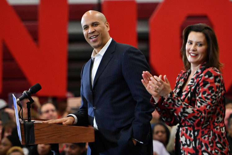 New Jersey Senator Cory Booker (left) speaks onstage alongside Michigan Governor Gretchen Whitmer during a Democratic presidential candidate Joe Biden's campaign rally at Renaissance High School in Detroit, Michigan on March 9, 2020. 