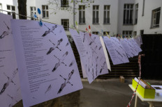 A poem with the title 'Lockdown' hangs on a clothes line, part of the 'Balconies, Life, Art, Pandemic, and Proximity' exhibition, in Berlin on April 12, 2020, amid a new coronavirus COVID-19 pandemic. 