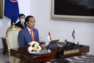 President Joko "Jokowi" Widodo attends a virtual ASEAN Plus Three Summit meeting at the Presidential Palace on April 14. 