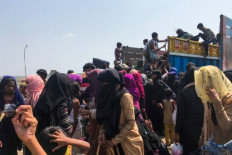 Rohingya refugees get in a truck following their arrival by a boat in Teknaf on 16 April 2020. Thirty-two Rohingya died on an overcrowded fishing trawler stranded in the Bay of Bengal for nearly two months, officials said April 16 after hundreds of 