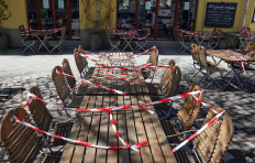 Locked seats and tables stand in front of a restaurant, as the spread of the coronavirus disease (COVID-19) continues in Berlin, Germany, April 20, 2020. 