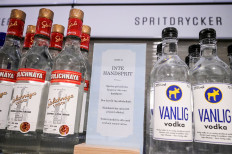 A sign reading 'Not hand sanitizer' sits among vodka bottles at a Systembolaget (Swedish Alcohol Retailing Monopoly) shop, as the spread of the coronavirus disease (COVID-19) continues, in Stockholm, Sweden April 21, 2020.