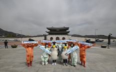 Members of the Asian Citizen's Center for Environment and Health perform during an Earth Day event in opposition to climate change at Gwanghwamun square in Seoul on April 22, 2020.