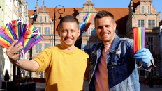 Gay couple Dawid Mycek and Jakub Kwiecinski pose with the rainbow-patterned face masks on a street in Gdansk, Poland April 8, 2020. 