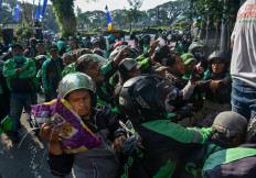 Thousands of ride-hailing app drivers jostle to receive basic necessities such as rice and eggs in front of in front of the Malang City Hall building, East Java, on April, 23, 2020. Malang was a red zone for the Covid-19 corona virus epidemic, with many in the gig economy struggling to earn enough to support their families. 