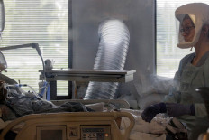 A nurse cares for a coronavirus disease (COVID-19) patient in the COVID ICU at the University of Washington Medical Center - Montlake during the COVID-19 outbreak in Seattle, Washington, US April 24, 2020.  