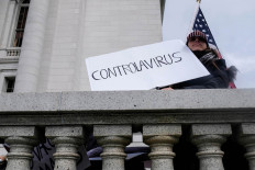 A protester against the state's extended stay-at-home order to help slow the spread of coronavirus disease (COVID-19) demonstrates at the Capitol building in Madison, Wisconsin, US April 24, 2020.  
