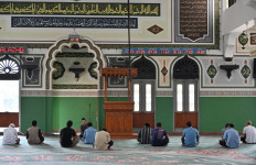 Indonesian Muslim men attend a short sermon after noon prayers at the Al Azhar mosque on the 3rd day of Ramadan in Jakarta on April 26, 2020.