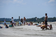 People relax on the Beach amid the Coronavirus pandemic in Tybee Island, Georgia on April 25, 2020. 