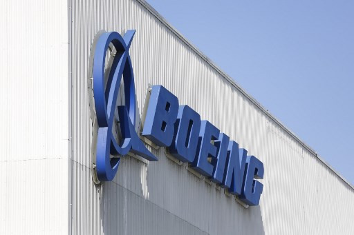 In this file photo the Boeing logo is pictured at its Renton Factory, where the Boeing 737 MAX airliners are built in Renton, Washington on April 20, 2020. Boeing's head said on Monday that restoring the dividend could take three-to-five years as the company girds for a slow air travel recovery in the wake of the coronavirus crisis. 