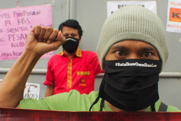 Workers take part in a protest on May Day, or International Workers' Day, in Tangerang, Banten on May 1 to call on lawmakers to drop omnibus law discussions and focus on handling the COVID-19 coronavirus outbreak. 