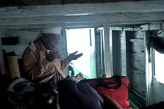 A passenger prays in a narrow cabin. JP/Edy Susanto