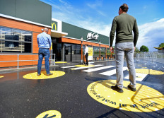 Customers wait outside on social distancing markings at a prototype location of fast food giant McDonald's for restaurants which respect the 1.5m social distancing measure, amid the coronavirus disease (COVID-19) outbreak, in Arnhem, Netherlands, May 1, 2020. 