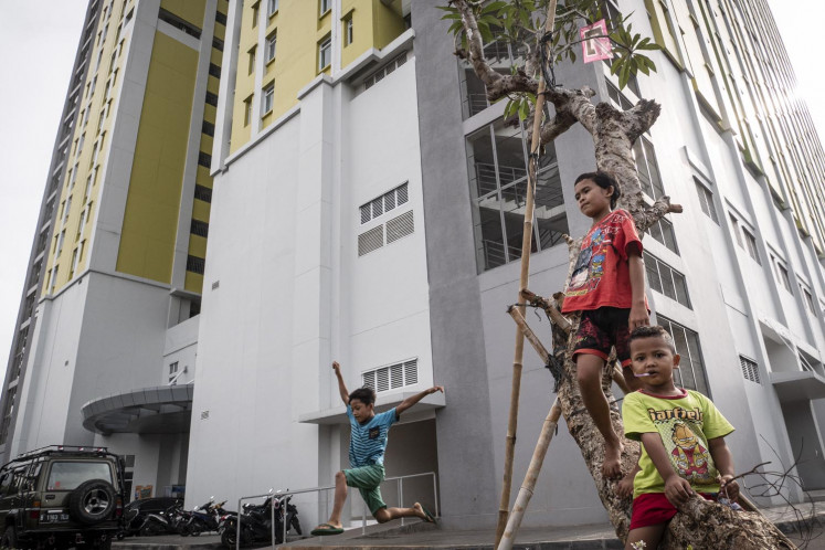 Children play in the yard of the Pasar Rumput Simple Rental Apartments (Rusunawa) on May 4, 2020 in Jakarta.