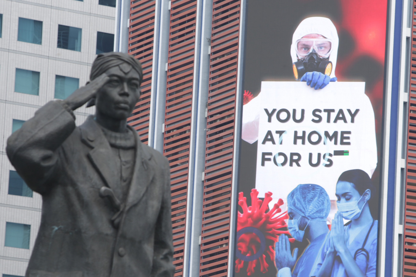 
An outdoor advertisement at an office building at the Sudirman business district, Jakarta appeals the people to stay home to halt the spread of the coronavirus
