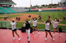 Cheerleaders wear protective face masks during a game between the SK Wyverns and Hanwha Eagles at Munhak Baseball Stadium, Incheon, South Korea, on May 5. 
