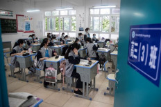 Students in China's virus center Wuhan return to school