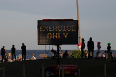 Australia sets plan to end most COVID-19 restrictions by July