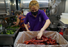Hawker Kristen Choong wears a protective mask as she prepares ingredients with her mother Lai Yau Kiew at their Hong Lim Hawker Centre stall, amid the coronavirus disease (COVID-19) outbreak in Singapore on May 10, 2020. 