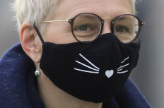 A woman wearing a face mask takes part in the 'Mask Fashion Week' in Vilnius, LIthuania, on May 5, 2020. 