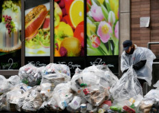 A woman looks through recycling bags on April 21, 2020 in New York City. Green groups worry about plastic 'onslaught' in Southeast Asia