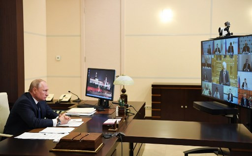 Russian President Vladimir Putin addresses the nation via teleconference at the Novo-Ogaryovo state residence outside Moscow on May 11, 2020. President Vladimir Putin on May 11, 2020 said Russia's non-working period imposed to contain the spread of the coronavirus will be lifted from May 12. 