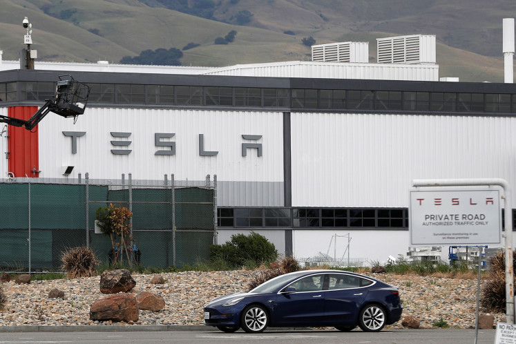 Tesla zooms past $1 trillion market cap on bet that the EV future