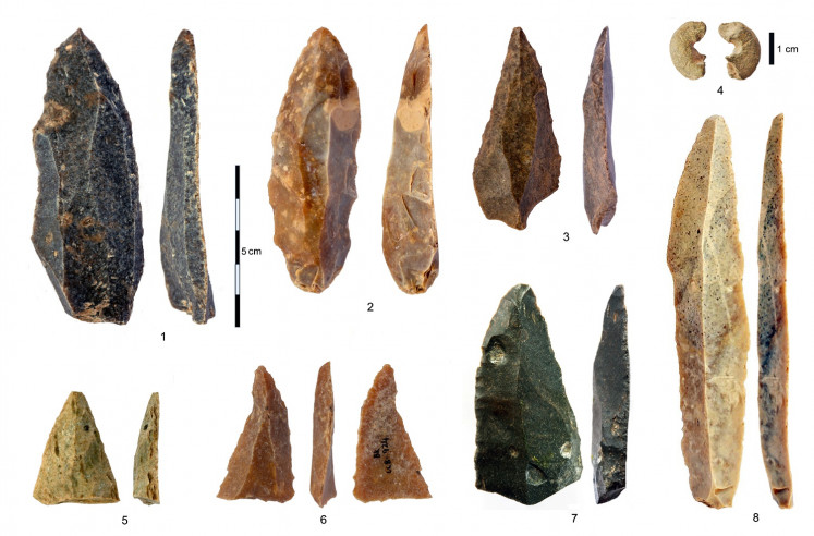 Stone artifacts from Bacho Kiro Cave in Bulgaria of pointed blades and fragments, sandstone bead with morphology similar to bone beads and the longest complete blade are seen in an image released May 11, 2020. 