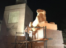 An undated handout picture provided by Egypt's Ministry of Antiquities on May 2, 2020 shows a worker setting one of four restored ram-headed sphinxes, symbolizing the ancient Egyptian god Amun, transported over 700 kilometres from their original location at Karnak temple in Luxor, at its new location in the center of Tahrir square in the capital Cairo.
