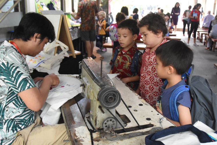 Spirit of stitching: With the help of a machine-embroidery artist, young artists at JIS’ Pattimura elementary school campus create various items for sale, such as tote bags, pillow covers and small pillow ornaments that they designed themselves.