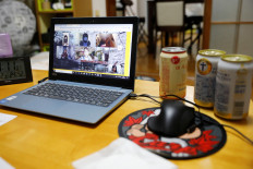 Participants of the online drinking party service 'Tacnom' are seen on Anzu's laptop screen at his house in Yokohama, Japan, on May 2, 2020.