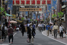 People walk through a shopping area in Tokyo on May 12, 2020.
