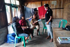 A high school teacher (right) distributes a graduation letter to a student at her home in Borong, East Manggarai, East Nusa Tenggara, on May 5. Teachers and principals of schools in Borong traveled to each of their student’s house to hand-deliver their graduation letter and also discourage mass gatherings. JP / Markus Makur